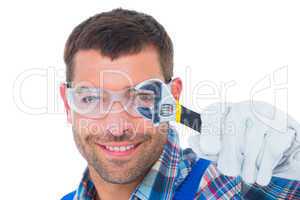 Happy repairman looking through wrench