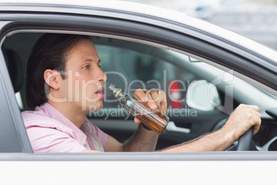 Man drinking alcohol while driving