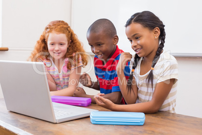 Cute pupils using computer