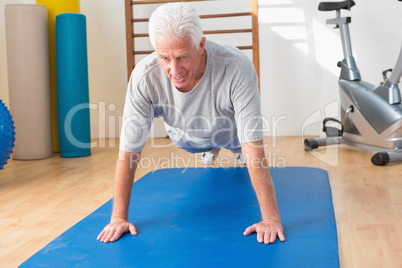 Senior man in plank position