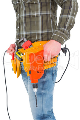 Smiling manual worker holding drill machine