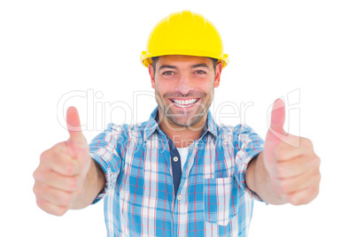 Smiling manual worker gesturing thumbs up