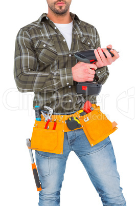 Manual worker holding gloves and hammer power drill