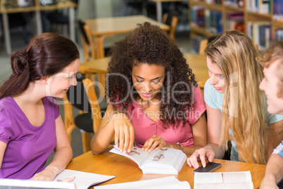 College students doing homework in library