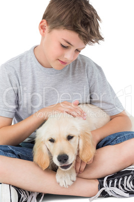 Boy stroking dog over white background