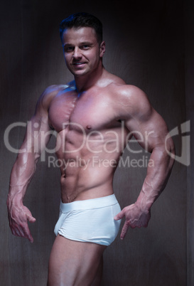 Muscular Man in White Boxer Shorts Looking Down