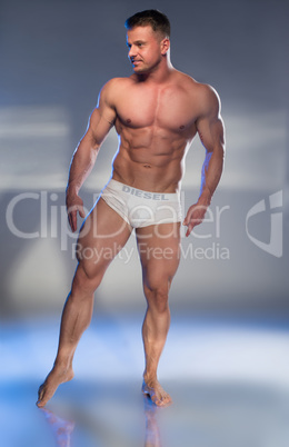 Muscular Man in White Boxer Shorts Looking Down