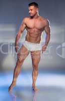 Muscular Man in White Boxer Shorts Looking Down