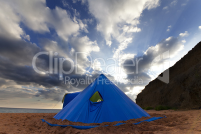 Conical tent on summer beach in evening