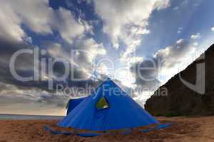 Conical tent on summer beach in evening