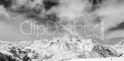 Black and white snowy mountains at wind day