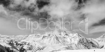 Black and white snowy mountains at wind day