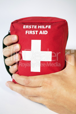 First aid kit with two hands - english and german tittle