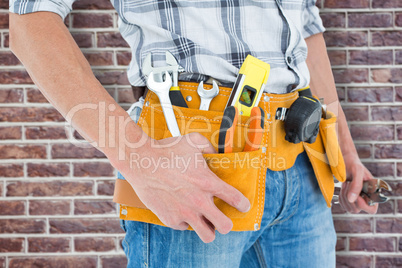 Composite image of cropped image of technician with tool belt ar