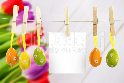 Composite image of hanging easter eggs