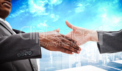 Composite image of businessman going shaking a hand