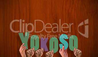 Composite image of hands holding up yokoso