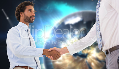 Composite image of young businessmen shaking hands in office