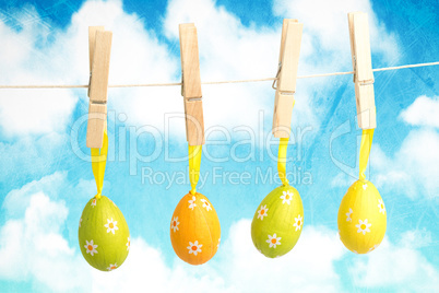 Composite image of hanging easter eggs