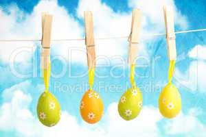 Composite image of hanging easter eggs