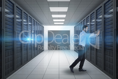 Composite image of businessman in suit pushing with effort