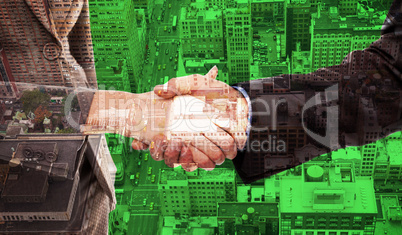 Composite image of close up of two businesspeople shaking their