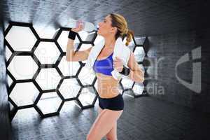 Composite image of strong blonde drinking from water bottle