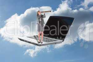 Composite image of businesswoman looking through a telescope