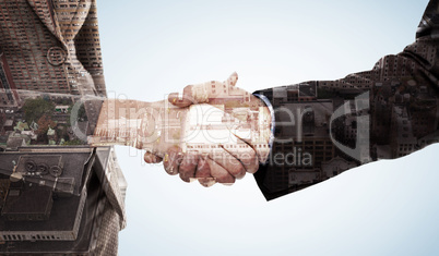 Composite image of close up of two businesspeople shaking their