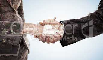 Composite image of close up of two businesspeople shaking their