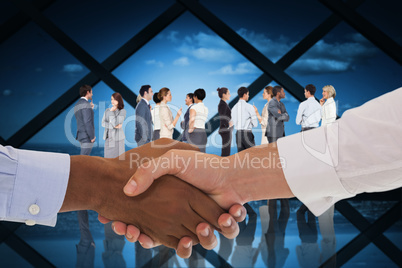 Composite image of close-up shot of a handshake in office