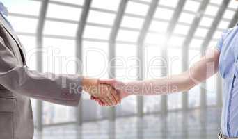 Composite image of handshake between two women