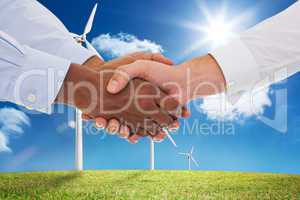 Composite image of close-up shot of a handshake in office