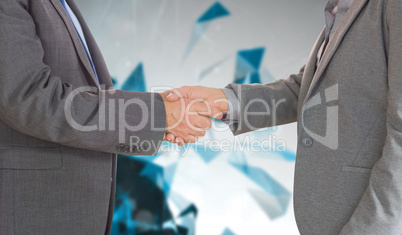 Composite image of close up on two businesspeople shaking hands