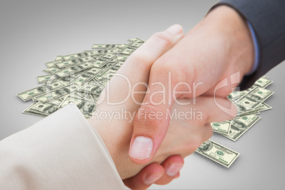 Composite image of close up on new partners shaking hands