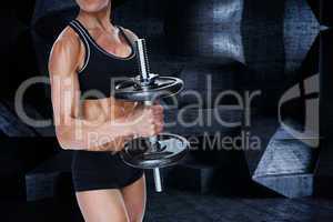 Composite image of female strong bodybuilder holding large black