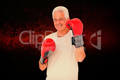 Composite image of senior man in boxing gloves