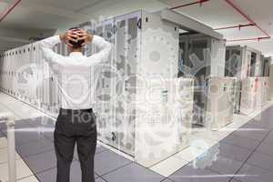 Composite image of businessman standing back to camera hands on