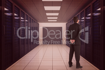 Composite image of businessman standing and looking