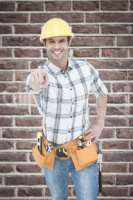 Composite image of handyman pointing over white background