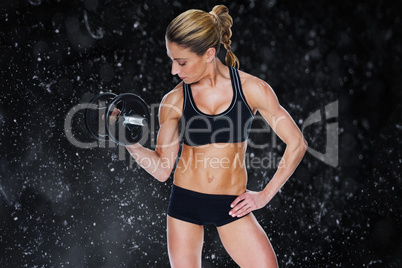 Composite image of female bodybuilder holding large black dumbbe