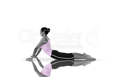 Composite image of side view of a fit young woman doing the cobr