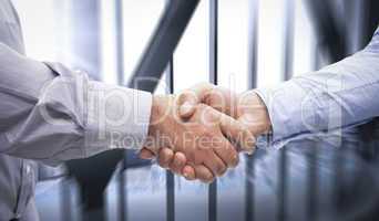 Composite image of men shaking hands
