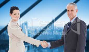 Composite image of smiling business people shaking hands while l