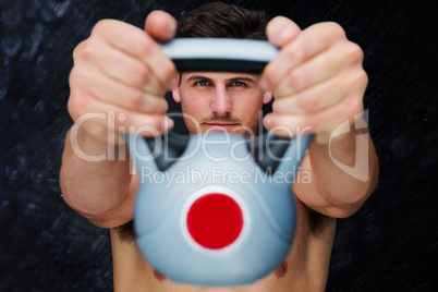 Composite image of bodybuilder holding kettlebell