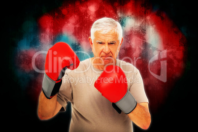 Composite image of portrait of a determined senior boxer