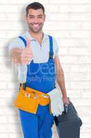Composite image of happy repairman with toolbox gesturing thumbs
