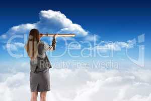 Composite image of businesswoman looking through a telescope