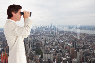 Composite image of businessman using binoculars