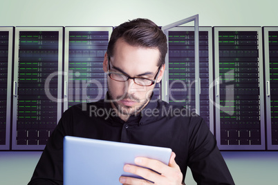 Composite image of cheerful businessman in glasses using tablet